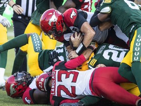 Calgary Stampeders quarterback Tommy Stevens (15) dives in over players for the touchdown against the Edmonton Elks during first half CFL action in Edmonton, Alta., on Saturday September 10, 2022.