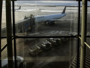 A plane is being boarded at the Edmonton International airpot in Edmonton Alta, on Thursday December 2, 2021.