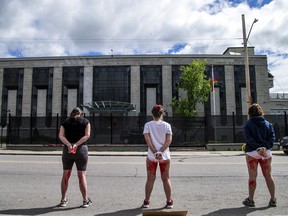 Protesters against the Ukraine war stand outside the Russian embassy in Ottawa, May 28, 2022.