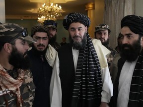 Bashir Noorzai, center, a senior Taliban detainee held at Guantanamo attends his release ceremony, at the Intercontinental Hotel, in Kabul, Afghanistan, Monday, Sept. 19, 2022. Bashir Noorzai, a notorious drug lord and member of the Taliban, told reporters in Kabul on Monday that he spent 17 years and six months in the U.S. detention center at Guantanamo Bay, and that he was the last Taliban prisoner there. Taliban-appointed Foreign Minister Amir Khan Muttaqi said Monday that the released American was Mark Frerichs, a Navy veteran and civilian contractor kidnapped in Afghanistan in 2020.