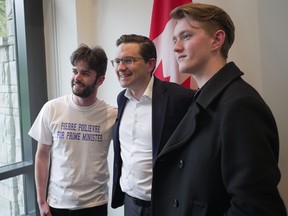 Federal Conservative leadership candidate Pierre Poilievre, centre, poses for photographs with supporters during a meet and greet at the University of British Columbia in Vancouver on Thursday, April 7, 2022.