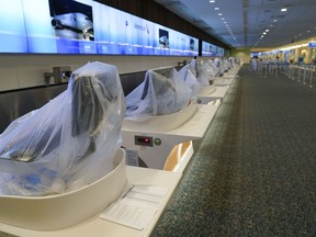 American Airlines check-in counters are closed at Orlando International Airport ahead of Hurricane Ian, Wednesday, Sept. 28, 2022, in Orlando, Fla.