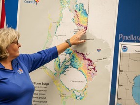 Emergency Management Director Cathie Perkins references a map indicating where storm surge would impact the county, urging anyone living in those areas to evacuate, during a press conference regarding Hurricane Ian at the Pinellas County Emergency Operations Center, Monday, Sept. 26, 2022 in Largo, Fla. Hurricane Ian was growing stronger as it approached the western tip of Cuba on a track to hit the west coast of Florida as a major hurricane as early as Wednesday.