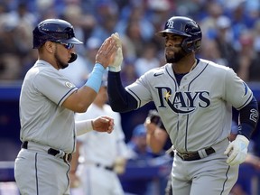 Tampa Bay Rays third baseman Isaac Paredes (17) congratulates teammate Yandy Diaz (21) after scoring on a three run home-run by Diaz during second inning MLB baseball action against the Toronto Blue Jays, in Toronto, Thursday, Sept. 15, 2022.
