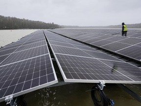 FILE - Solar panels are installed at a floating photovoltaic plant on a lake in Haltern, on Friday, April 1, 2022. Long periods of sunshine took solar power generation in Europe to a record high this summer, helping reduce the need for gas imports, according to a report Thursday. Energy think tank Ember said the European Union generated 12% of its electricity from solar power from May to August, up from 9% during the same period last year.