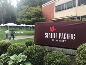 Students walk on the campus of Seattle Pacific University in Seattle on Sunday, Sept. 11, 2022. A group of students, faculty and staff at the Christian university have sued leaders of the board of trustees for refusing to scrap an employment policy barring people in same-sex relationships from full-time jobs at SPU.