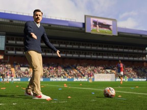 Ted Lasso, played by actor Jason Sudekis in the series "Ted Lasso", is seen on the sidelines in an undated handout screenshot from the game FIFA 23. Electronic Arts and Warner Bros. Interactive Entertainment announced Wednesday that AFC Richmond, the team managed by the affable Ted Lasso in the hit Apple TV+ series, will be available to gamers across multiple game modes in the upcoming EA Sports FIFA 23 video game.
