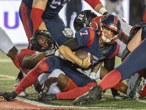 Montreal Alouettes quarterback Trevor Harris (7) is sacked by the Ottawa Redblacks during second half CFL football action in Montreal, Friday, Sept. 2, 2022.