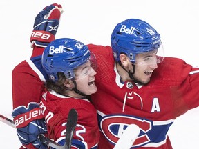 Montreal Canadiens' Cole Caufield, left, celebrates with teammate Nick Suzuki after scoring against the St. Louis Blues during third period NHL hockey action in Montreal, Thursday, February, 17, 2022.&ampnbsp;Suzuki is the new captain of the Canadiens.THE&ampnbsp;CANADIAN PRESS/Graham Hughes