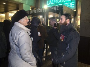 Jeremy MacKenzie, right, talks with an unidentified woman outside the venue where Omar Khadr, the former child soldier is speaking in Halifax on Monday, February 10, 2020. Jeremy MacKenzie, the founder of the online group "Diagolon," has been arrested in Nova Scotia on charges related to an incident in Saskatchewan.