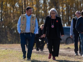 Gov.-Gen. Mary Simon, right, and Chief Wally Burns of James Smith Cree Nation walk during their visit the victims' gravesite of the mass stabbing incident at James Smith Cree Nation, Sask., on Wednesday, September 28, 2022.