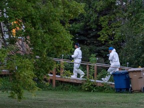 Investigators with protective equipment enter a house in a crime scene in Weldon, Sask., Sunday, Sept. 4, 2022. Saskatchewan RCMP has confirmed that there are 10 dead while 15 are injured following the stabbings that occurred at James Smith Cree Nation and Weldon in Saskatchewan.