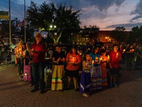 People gather at a vigil remembering the victims of a mass stabbing incident at James Smith Cree Nation and Weldon, Sask., in front of City Hall in Prince Albert, Sask., on Wednesday, September 7, 2022. The federal minister of Indigenous Services is speaking out after visiting the site of a mass killing in Saskatchewan.THE CANADIAN PRESS/Heywood Yu