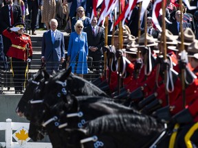 Prince Charles and Camilla, Duchess of Cornwall, watch a performance of the RCMP Musical Ride during the Canadian Royal tour&ampnbsp;in Ottawa, Wednesday, May 18, 2022.&ampnbsp;The Royal Canadian Mounted Police says five of its members will be leading queen Elizabeth's funeral procession in London, England on Monday.