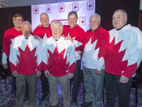 Team Canada 1972 players Serge Savard, left, Yvan Cournoyer, Ken Dryden, Pat Stapleton, Peter Mahovlich, Phil Esposito and Guy Lapointe, right, pose for photos at a news conference, in Montreal on Tuesday, Feb. 9, 2016. The generation of Canadians who can remember watching the 1972 Summit Series shrinking, and the Canadians and Soviet players in it fewer with each passing year, documentarians had compelling reasons in addition to a 50th anniversary to retell a mythological hockey story.