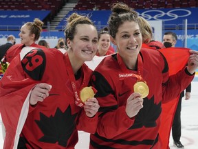 Team Canada's Marie-Philip Poulin (29) and forward Rebecca Johnston (6) celebrate with their gold medals after defeating the United States in women's hockey gold medal game action at the 2022 Winter Olympics, in Beijing, Thursday, Feb. 17, 2022. Johnston has been hired by the NHL's Calgary Flames in a player development role.