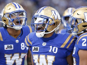Winnipeg Blue Bombers' Nic Demski (10), Brendan OLeary-Orange (84) and Brady Oliveira (20) celebrate Demskis touchdown against the Saskatchewan Roughriders during the first half of CFL football action in Winnipeg Saturday, September 10, 2022.THE CANADIAN PRESS/John Woods