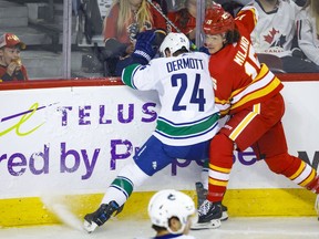 Vancouver Canucks defenceman Travis Dermott, left, checks Calgary Flames forward Sonny Milano during first period NHL pre-season hockey action in Calgary, Alta., Sunday, Sept. 25, 2022.&ampnbsp;Despite putting up 14 goals and 34 points in 66 games with the Anaheim Ducks in 2021-22, Milano was surprisingly cut loose and hit the open market after not receiving a qualifying offer.