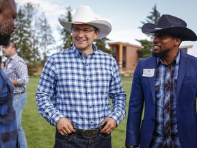 Pierre Poilievre, centre, Conservative party leadership candidate, attends a party barbecue in Calgary, Alta., Saturday, July 9, 2022.
