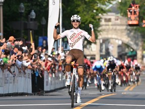 Benoit Cosnefroy of France reacts as he cosses the finish to win the Grand Prix cycliste de Quebec, in Quebec City, Friday, Sept. 9, 2022.