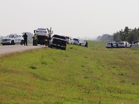 Police and investigators are seen at the side of the road outside Rosthern, Sask., on Wednesday, Sept. 7, 2022. RCMP say Myles Sanderson, a suspect in a deadly stabbing rampage northeast of Saskatoon over the weekend, has been taken into custody near the town of Rosthern on the fourth day of a massive manhunt.