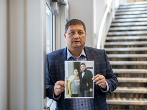 Mark Arcand, who's sister Bonnie Burns was killed during a series of violence attacks at James Smith Cree Nation holds a photo in Saskatoon, Wednesday, September 7, 2022.
