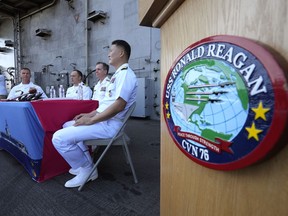 Rear Adm. Michael Donnelly, commander of the carrier strike group, second from right, listens to a reporter's question during a news conference on the deck of the nuclear-powered aircraft carrier USS Ronald Reagan in Busan, South Korea, Friday, Sept. 23, 2022. The nuclear-powered aircraft carrier USS Ronald Reagan arrived in the South Korean port of Busan on Friday ahead of the two countries' joint military exercise that aims to show their strength against growing North Korean threats.