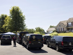 Law enforcement gather at the scene Friday, Sept. 9, 2022, in Elk Mills, Md., about 60 miles (97 km) northeast of Baltimore. Five people were found dead inside a home in northeastern Maryland on Friday after deputies were called to investigate a report of a shooting, authorities said.