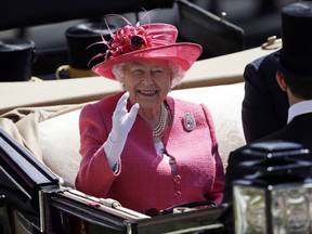 FILE - Britain's Queen Elizabeth II arrives on the third day of the Royal Ascot horse race meeting, which is traditionally known as Ladies Day, in Ascot, England, Thursday, June 21, 2018. Horse racing was Queen Elizabeth II's big sporting love. She first rode a horse at the age of 3 and would inherit the breeding and racing stock of her father, King George VI, when she acceded to the throne in 1952.