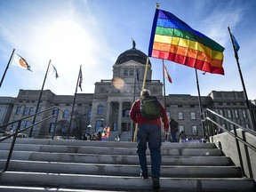 FILE - Demonstrators gather on the steps of the Montana State Capitol protesting anti-LGBTQ+ legislation on March 15, 2021, in Helena, Mont. Montana health officials have made permanent a rule that blocks transgender people from changing their birth certificates even if they undergo gender-confirmation surgery.
