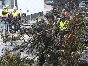 Cpl. Owen Donovan of the Cape Breton Highlanders removes brush under the direction of Nova Scotia Power officials along Steeles Hill Road in Glace Bay, N.S., Monday, Sept. 26, 2022.&nbsp;Justin Trudeau is scheduled to travel today to P.E.I. and Nova Scotia, where he will meet with residents and inspect the extensive damage caused by post-tropical storm Fiona. THE&nbsp;CANADIAN PRESS/Vaughan Merchant