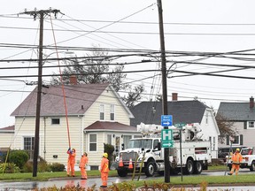 Crews from Nova Scotia Power work on reconnecting the power grid to the Glace Bay Hospital knocked out by Hurricane Fiona, in Glace Bay, N.S., Monday, Sept. 26, 2022. The premier of Nova Scotia has issued a stinging rebuke to the telecommunications companies that serve the province, saying too many Nova Scotians are still without cellphone service, four days after post-tropical storm Fiona roared across Atlantic Canada.