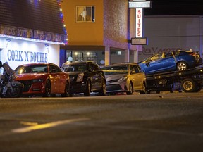 A blue Honda is loaded onto a flatbed tow truck in Wildwood, N.J., late Saturday, Sept. 24, 2022. Authorities say at least two people were killed amid multiple crashes at a pop-up car rally.