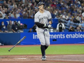 New York Yankees right fielder Aaron Judge (99) tosses his bat as he gets walked by Toronto Blue Jays starting pitcher Kevin Gausman (34) during third inning American League MLB baseball action in Toronto on Monday, September 26, 2022.