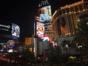 Images of Queen Elizabeth II on casino marquees are reflected by glass along the Las Vegas Strip, Thursday, Sept. 8, 2022, in Las Vegas. Queen Elizabeth II, Britain's longest-reigning monarch and a rock of stability across much of a turbulent century, died Thursday after 70 years on the throne. She was 96.