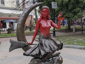 FILE - This image provided by Daniel Fury shows the "Bewitched" statue partially covered with red paint on June 6, 2022, in Salem, Mass. A man has plead guilty Tuesday, Sept. 20, 2022, to vandalizing the tourist favorite statue in Salem and will be sentenced to 18 months of probation for dousing the bronze statue with red paint earlier in the summer.