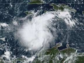 This satellite image provided by the National Oceanic and Atmospheric Administration shows Tropical Storm Ian over the central Caribbean on Saturday, Sept. 24, 2022. (NOAA via AP)