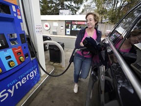FILE - Jennifer Quinn fills her SUV at a gas station Monday, March 7, 2022, in Needham, Mass. The average price of regular gasoline nationwide is up slightly Wednesday, Sept. 21, from a day earlier, the first time prices have climbed in 99 days.