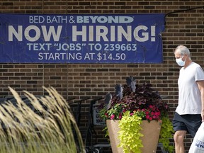 Hiring sign is displayed in Deerfield, Ill., Wednesday, Sept. 21, 2022. The number of Americans filing for jobless benefits dropped last week, a sign that few companies are cutting jobs despite high inflation and a weak economy. Applications for unemployment benefits for the week ending Sept. 24 fell by 16,000 to 193,000, the Labor Department reported Thursday, Sept. 29.