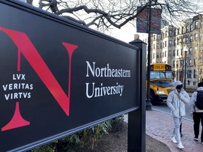 FILE - Students walk on the Northeastern University campus in Boston on Jan. 31, 2019. A police bomb squad sealed off part of the campus of Northeastern University late Tuesday, Sept. 13, 2022, to examine a pair of suspicious packages, and there were unconfirmed reports of an explosion and minor injuries to at least one person.