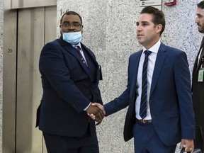 FILE - Eliseo DeLeon, left, is greeted by his lawyer Cary London in the hallway at the Kings County Supreme Court in the Brooklyn borough of New York on Wednesday Aug. 31, 2022. DeLeon was sentenced Thursday, Sept. 15, 2022, to 20 years to life for the 1995 killing of Fausto Cordero. DeLeon spent 24 years behind bars before his conviction was overturned in 2019 amid questions about a prominent detective's conduct, so he is now eligible to immediately seek parole.