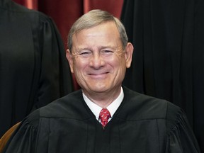 FILE - Chief Justice John Roberts sits during a group photo at the Supreme Court in Washington, April 23, 2021. Roberts is set to make his first public appearance since the U.S. Supreme Court overturned Roe v. Wade, speaking Friday night, Sept. 9, 2022, at a judicial conference in Colorado.