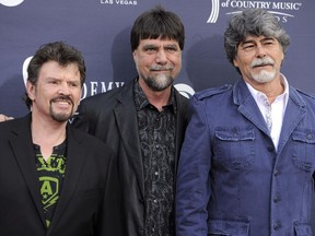 FILE - In this April 3, 2011, photo, Jeff Cook, from left, Teddy Gentry and Randy Owen of Alabama arrive at the 46th Annual Academy of Country Music Awards in Las Vegas. Gentry, a founding member of and bass player for the country music super group, was arrested Monday, Sept. 12, 2022, on a misdemeanor marijuana possession charge. He also was charged with possession of drug paraphernalia. Gentry, 70, of Fort Payne was booked into the Cherokee County Jail in northeast Alabama and released about a half-hour later.