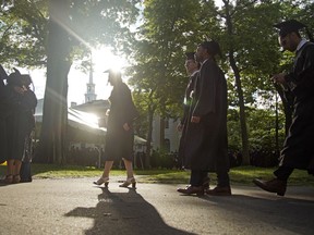 FILE - Graduates walk at a Harvard Commencement ceremony held for the classes of 2020 and 2021, Sunday, May 29, 2022, in Cambridge, Mass. The Department of Education says borrowers who hold eligible federal student loans and have made voluntary payments since March 13, 2020, can get a refund.
