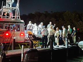 This image provided by Miami-Dade Fire Rescue shows agents at the scene of a boat crash near Boca Chita Key, Fla. Sunday, Sept. 4, 2022. (Miami-Dade Fire Rescue via AP)