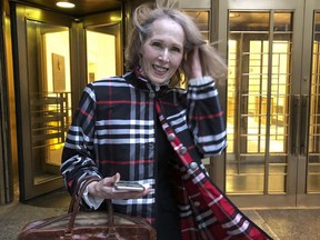 FILE - Columnist E. Jean Carroll leaves federal court, Feb. 22, 2022, in New York. A federal appeals court asked a Washington D.C. appeals court Tuesday, Sept. 27, 2022, to help it decide whether the United States should be substituted for former President Donald Trump as the defendant in a defamation lawsuit brought by Carroll, who says he raped her over a quarter century ago.