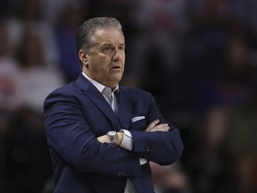 University of Kentucky men's basketball head coach John Calipari stands on the sidelines during the first half of the team's NCAA college basketball game against Florida, Saturday, March 5, 2022, in Gainesville, Fla. University police have arrested a woman for trying to enter Calipari's property. University spokeswoman Blair Conner said Lexington, Ky., Police were called to assist university police outside Calipari's residence Tuesday morning, Sept. 6, 2022.