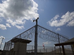 FILE - A fence stands at Elmore Correctional Facility in Elmore, Ala., June 18, 2015. Alabama inmates were in their second day of a work strike Tuesday, Sept. 27, 2022, refusing to labor in prison kitchens, laundries and factories to protest conditions in the state's overcrowded, understaffed lock-ups.