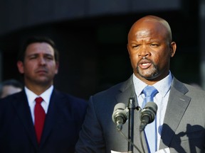 FILE - Acting Broward County Sheriff Gregory Tony, right, speaks after being introduced by Florida Gov. Ron DeSantis, left, at the Broward County Sheriff's Office in Fort Lauderdale, Fla., Jan. 11, 2019. It appears Tony, appointed by Gov. DeSantis after the Marjory Stoneman Douglas High School massacre in February 2018, lied when he did not disclose he had fatally shot another teenager when he was 14 and that he had used LSD, the state ethics commission found on Wednesday, Sept. 14, 2022.