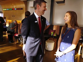 Tulsa District Attorney candidate Steve Kunzweiler, left, chats with his daughter Jennifer Kunzweiler during his watch party in the Republican runoff election on Aug. 26, 2014, in Tulsa, Okla. Kunzweiler was recovering Wednesday, Sept. 28, 2022, at his home in Tulsa, one day after police said he was stabbed by his adult daughter. Jennifer Kunzweiler, 30, was arrested following the stabbing at his home, according to a social media post Tuesday night by Tulsa Police Chief Wendell Franklin.
